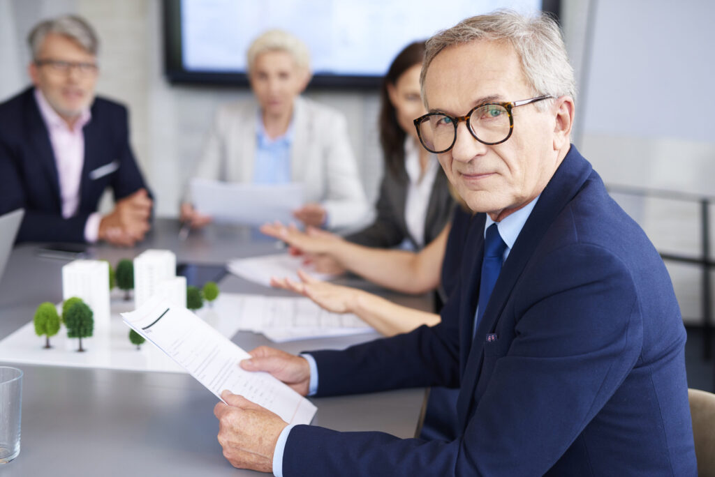 portrait of senior businessman during a conference 2026 01 06 10 56 35 utc scaled.jpg